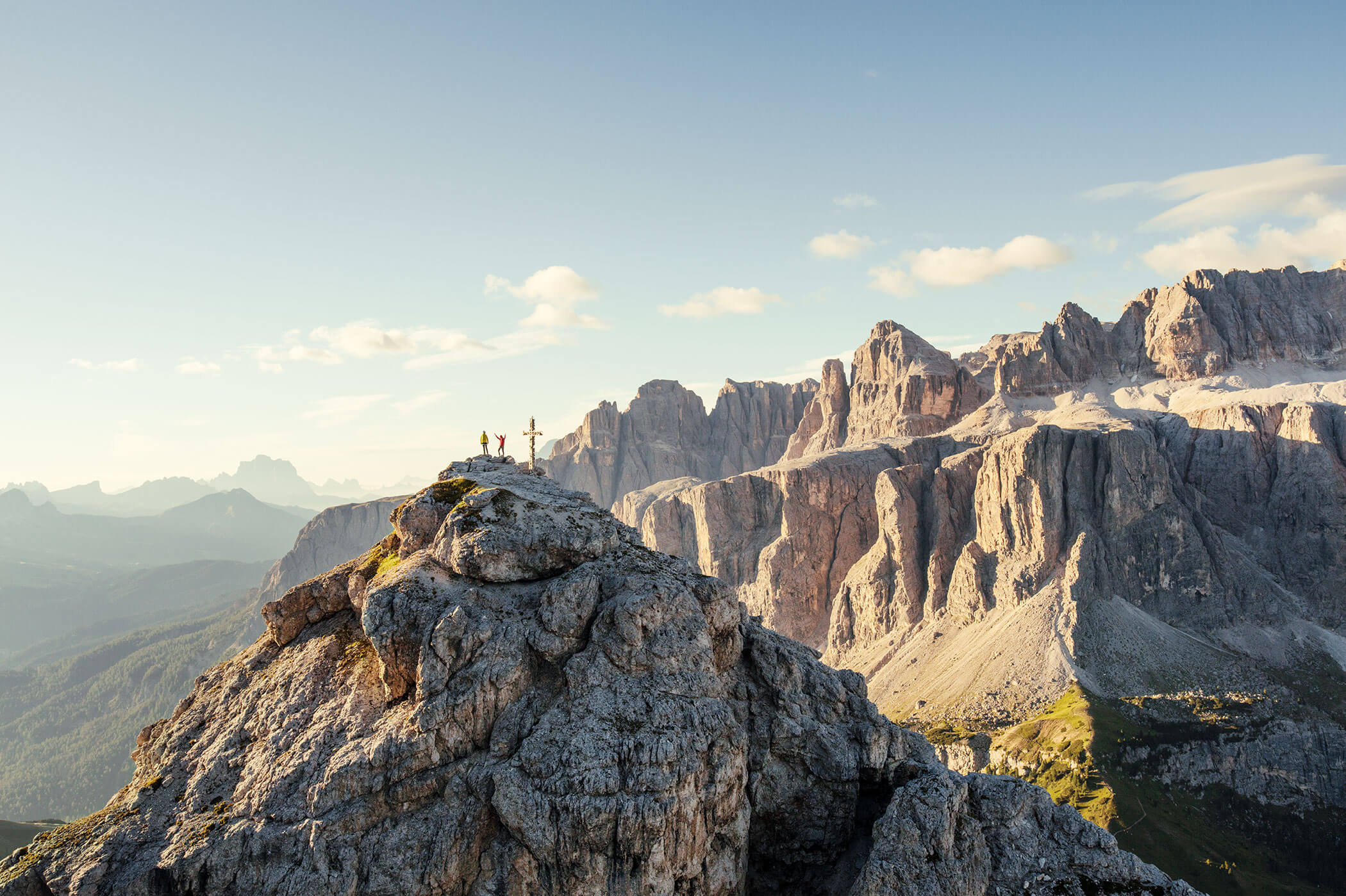 Two mountaineers on a summit and a wonderful mountain backdrop in the background - Hirschenhof